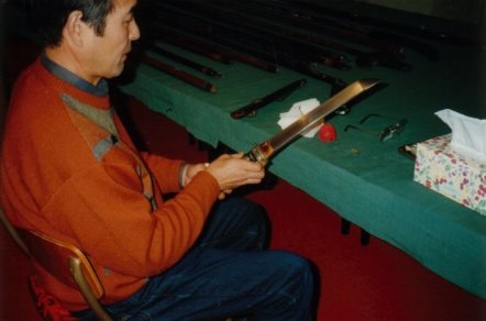 Japanese conservators inspect the Olveston weaponry collection.
